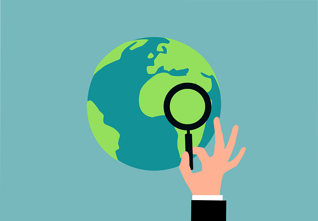 Illustration of the earth in the background and a hand holding a magnifying glass in the foreground