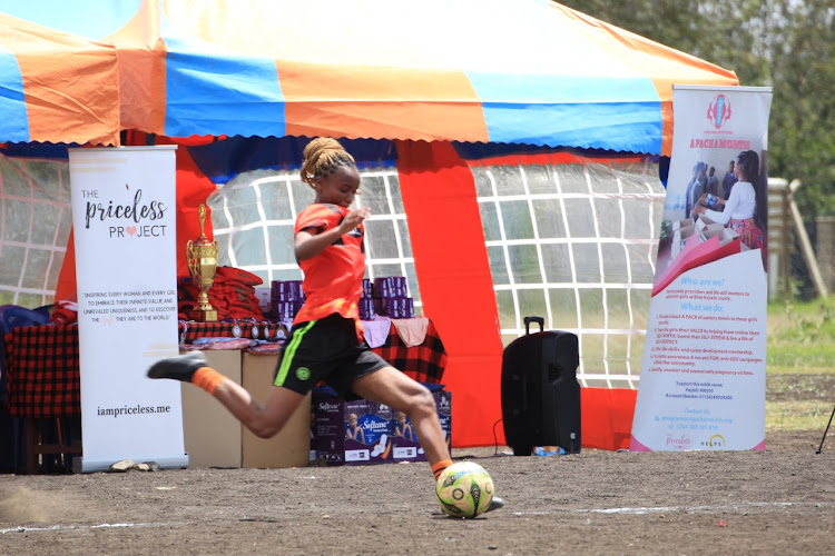 Stricker Mwanaidi of the team PAMEP kicks a ball during the Girls and Young Women Football tournament in Ngong, Kajiado North on December 31, 2022