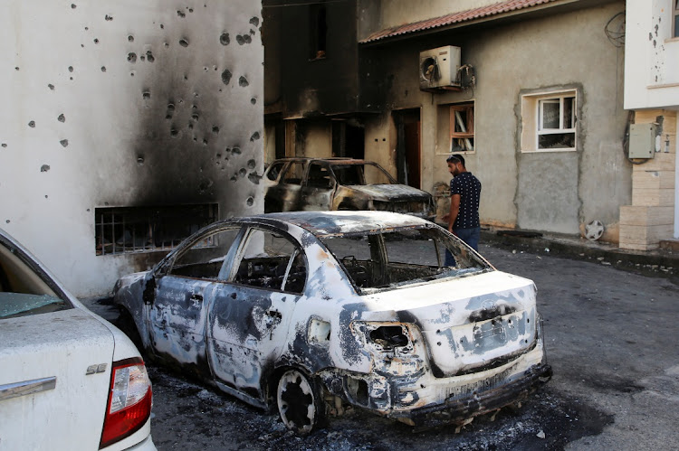 A man looks at a car burned during clashes in Tripoli, Libya, in this August 28 2022 file photo. Picture: REUTERS/HAZEM AHMED