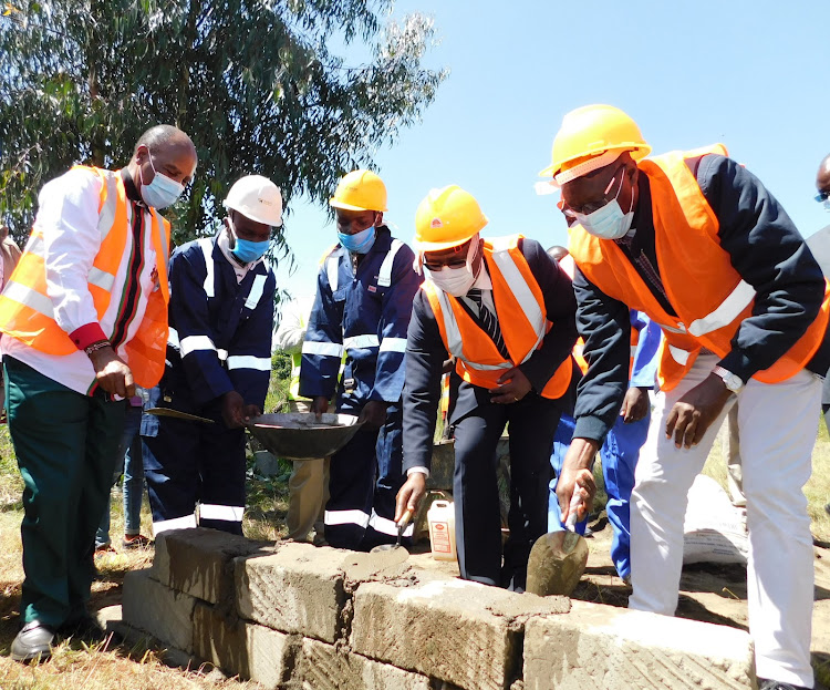 Nyandarua Governor Francis Kimemia (left), Trade Chief Administrative Secretary Lawrence Karanja (second right) and Trade PS Johnson Weru (right) lay the foundation stone for the construction of potato cold storage in Ol Kalou on Monday, June 29, 2020.