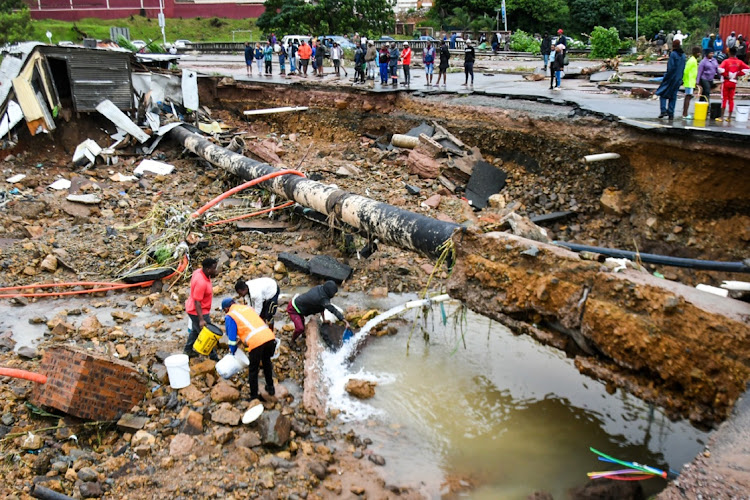 People collecting fresh water at the informal settlement between the M19 and Quarry Road on April 12, 2022 in Durban. Water and sanitation minister Senzo Mchunu says flooding resulted in damaged infrastructure critical for the provision of water and sanitation services.