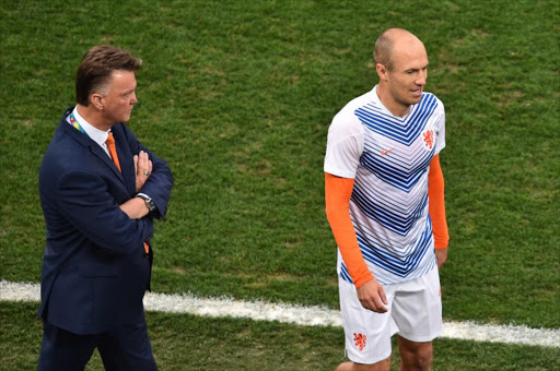 Netherlands' forward Arjen Robben (R) walks next to Netherlands' coach Louis van Gaal before the semi-final football match between Netherlands and Argentina of the FIFA World Cup at The Corinthians Arena in Sao Paulo on July 9, 2014. Reports suggest that Manchester United manager van Gaal has asked United to do everything they can to bring Robben back to the Premier League, where he previously had a spell at Chelsea. GABRIEL BOUYS / AFP