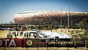 Football fans arrive in taxis at FNB Stadium in Soweto for a match.