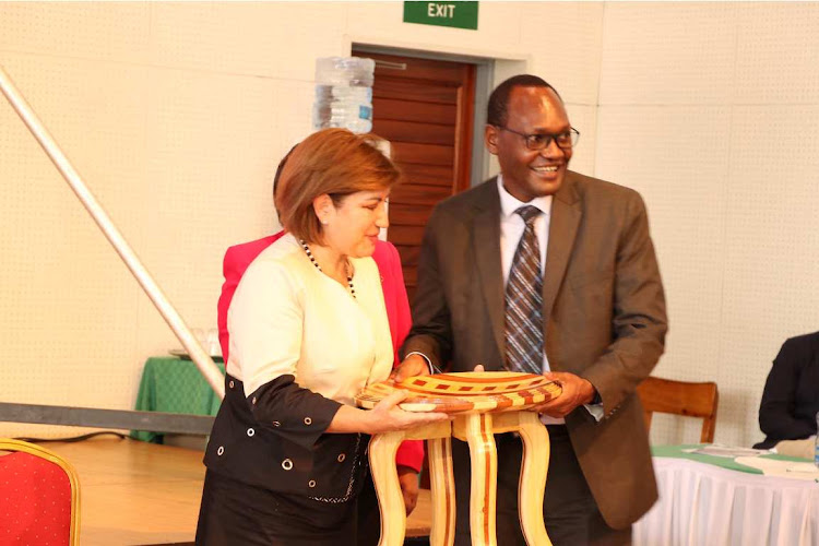 Colombia Deputy Ambassador Claudia Milena Vaca receives a gift from Environment PS Chris Kiptoo at Kefri in Muguga on November 26, 2021.