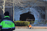 A view shows the crash site as emergency services personnel attend the scene after a vehicle crashed into an Apple store in Hingham, Massachusetts, US November 21, 2022.  