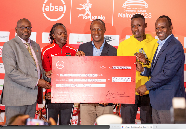 Absa Bank managing director, Abdi Mohammed (L) presents cheque to Sports PS Jonathan Mueke (C) and Kip Keino meet director Barnabas Korir (L) as Commonwealth 800m champion Mary Moraa ( 2nd L) and sprinter Wiseman Were looks on.