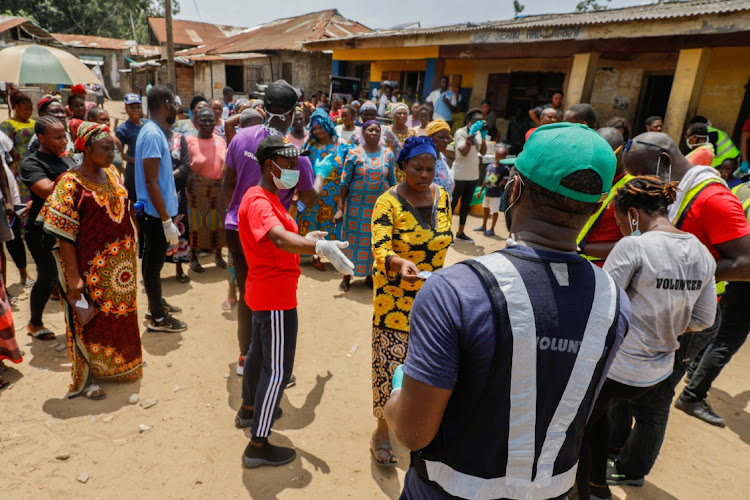 People queue for food parcels at a relief distribution point during the lockdown in Lagos, Nigeria.