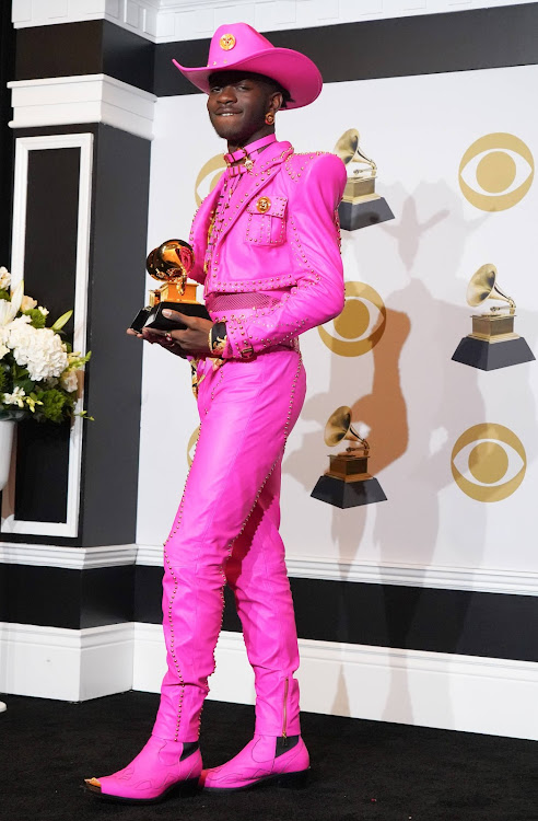 Lil Nas X poses in the press room with the awards for Best Music Video and Best Pop Duo/Group Performance during the 62nd Annual GRAMMY Awards at Staples Center in Los Angeles, California.