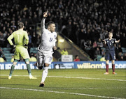 LIVELY: England's Alex Oxlade-Chamberlain is thrilled  after scoring  in their international friendly  against  Scotland   at Celtic Park in Glasgow on TuesdayPHOTO: ROBERT PERRY/EPA