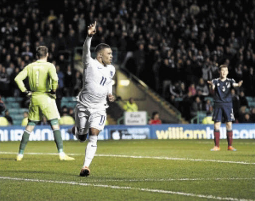 LIVELY: England's Alex Oxlade-Chamberlain is thrilled after scoring in their international friendly against Scotland at Celtic Park in Glasgow on TuesdayPHOTO: ROBERT PERRY/EPA