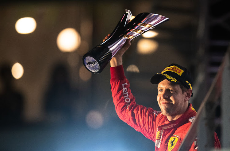 Race winner Sebastian Vettel of Germany and Ferrari celebrates on the podium during the F1 Grand Prix of Singapore at Marina Bay Street Circuit on September 22, 2019 in Singapore.