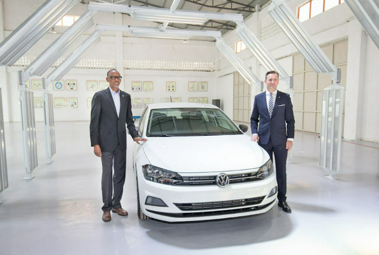 Rwandan President Paul Kagame and VWSA chief executive Thomas Schaefer with the first VW to be assembled at the new plant in Kigali.