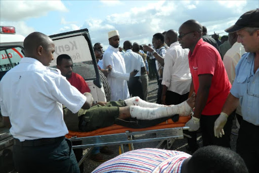 One of Garissa University terror attack victim being assisted into the aircraft at the Garissa airstrip yesterday.Photo Stephen Astariko