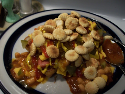 Plate with smothered hot dog. 