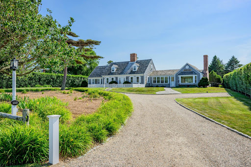 Gray house with chimneys and flower garden in this luxury property for sale in Chatham ($9,995,000 - 286 m²)