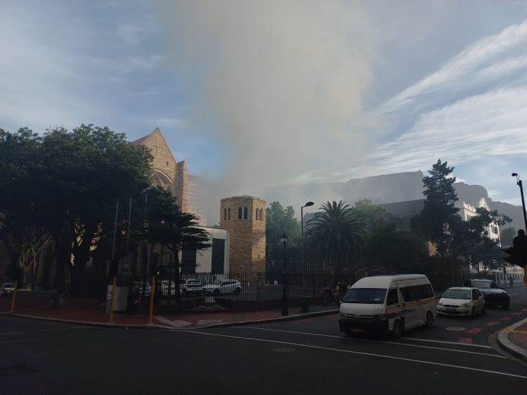 Smoke billowing from parliament behind St Geroge's Cathedral.