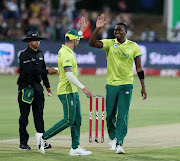 Proteas fast bowler Lungi Ngidi (R) celebrates with his captain Faf du Plessis (L) during the KFC T20 match between South Africa and Zimbabwe at the Senwes Park in Potchefstroom, North West, on October 12, 2018.