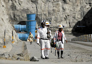 Workers return from a shift at Zimplats' Ngwarati mine. SA mining companies with inactive concessions in Zimbabwe could soon lose out if they don't use them.