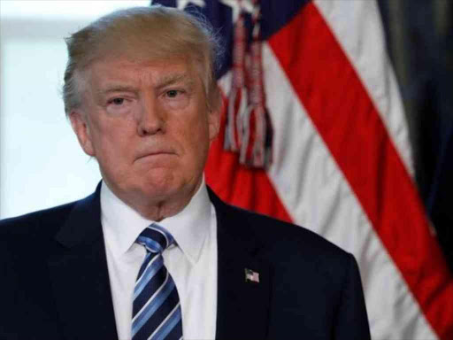 U.S. President Donald Trump looks on as Treasury Secretary Steve Mnuchin speaks at a signing ceremony at the Treasury Department in Washington, U.S., April 21, 2017. REUTERS