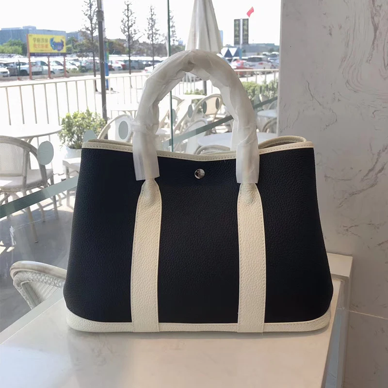 Ženska modna kožna torba od goveđe kože sa teksturom ličija, elegantna i izdržljiva, idealna za svakodnevnu upotrebu i posebne prilike.