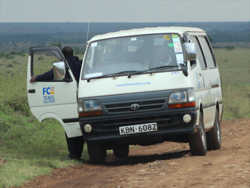 Tour van at lion zebra kill. /COURTESY