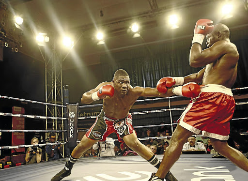 Akani Phuzi throws a punch at Mussa Ajibu in their international cruiserweight fight.