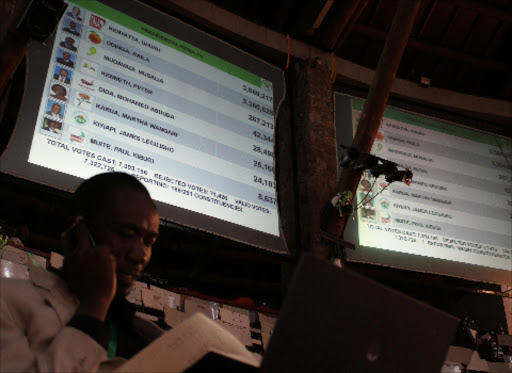 An agent follows the manual tallying process of the presidential vote at the national tallying centre in Bomas, Nairobi, on March 4, 2013.