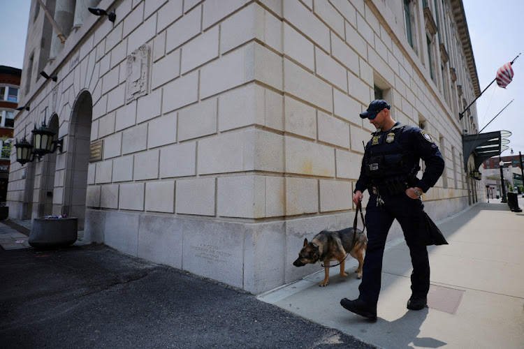 A police officer and dog patrol outside federal the courthouse before the detention hearing for Jack Douglas Teixeira, the US National Guardsman accused of leaking military secrets, in Worcester, Massachusetts, US, May 19, 2023.