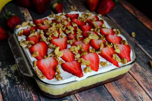 Banana Split Brownie Cake decorated in a baking dish.