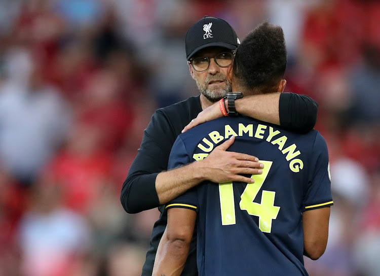 Liverpool manager Jürgen Klopp hugs Arsenal's Pierre-Emerick Aubameyang after the match.