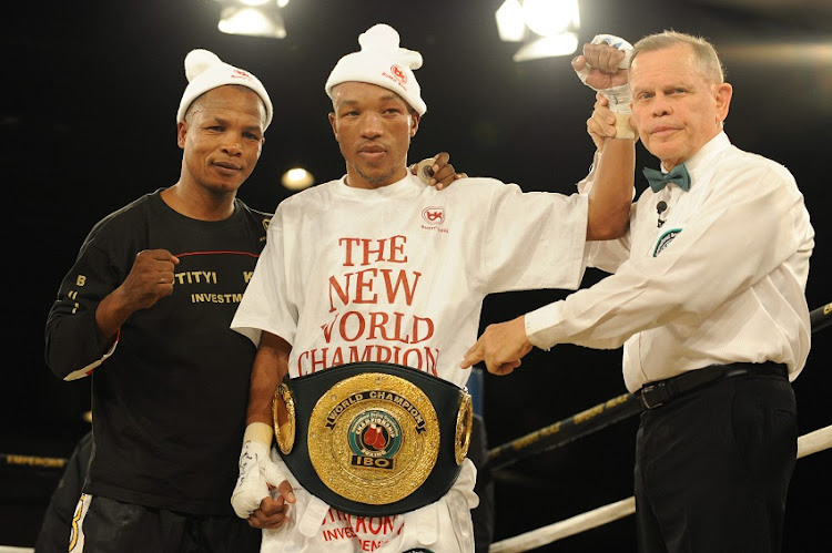 Welcome Ncita,Simpiwe Vetyeka and referee Roberto Ramirez during the vacant IBO International Boxing Organisation bantamweight title bout between Simpiwe Vetyeka and Eric Barcelona at Emperor's Palace on the 11 July 2009 in Kempton Park, Gauteng, South Africa.