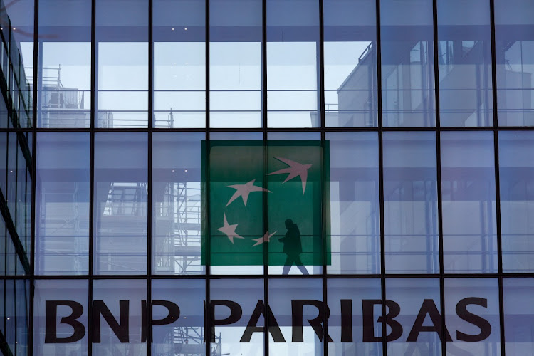 A man is silhouetted as he walks behind the BNP Paribas building in Issy-les-Moulineaux, Paris, France, February 3 2022. Picture: REUTERS/Gonzalo Fuentes