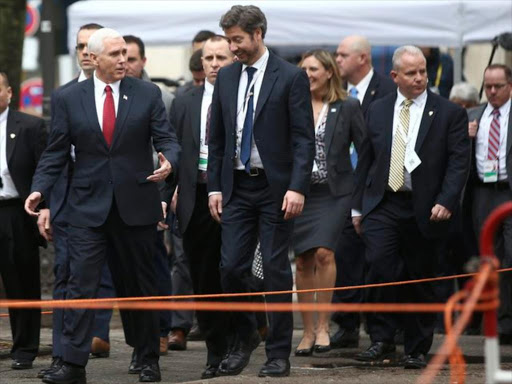 US Vice President Mike Pence walks with members of his delegation ahead of bilateral talks during the 53rd Munich Security Conference in Munich, Germany, February 18, 2017. /REUTERS