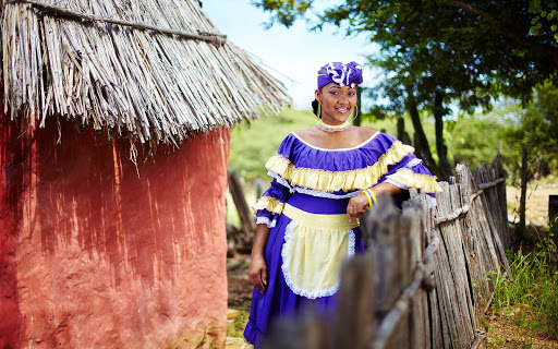 A local woman in traditional dress poses in Bonaire. 