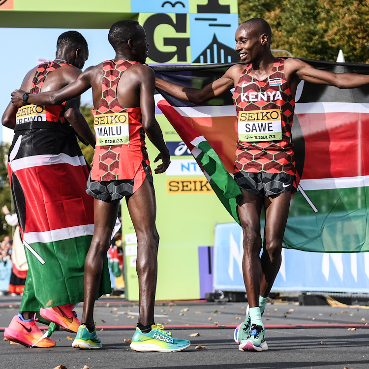 Sebastian Sawe celebrates with Samuel Mailu and Daniel Simiu after dominating the 21km race during the World Road Running Championships in Riga, Latvia, on Sunday