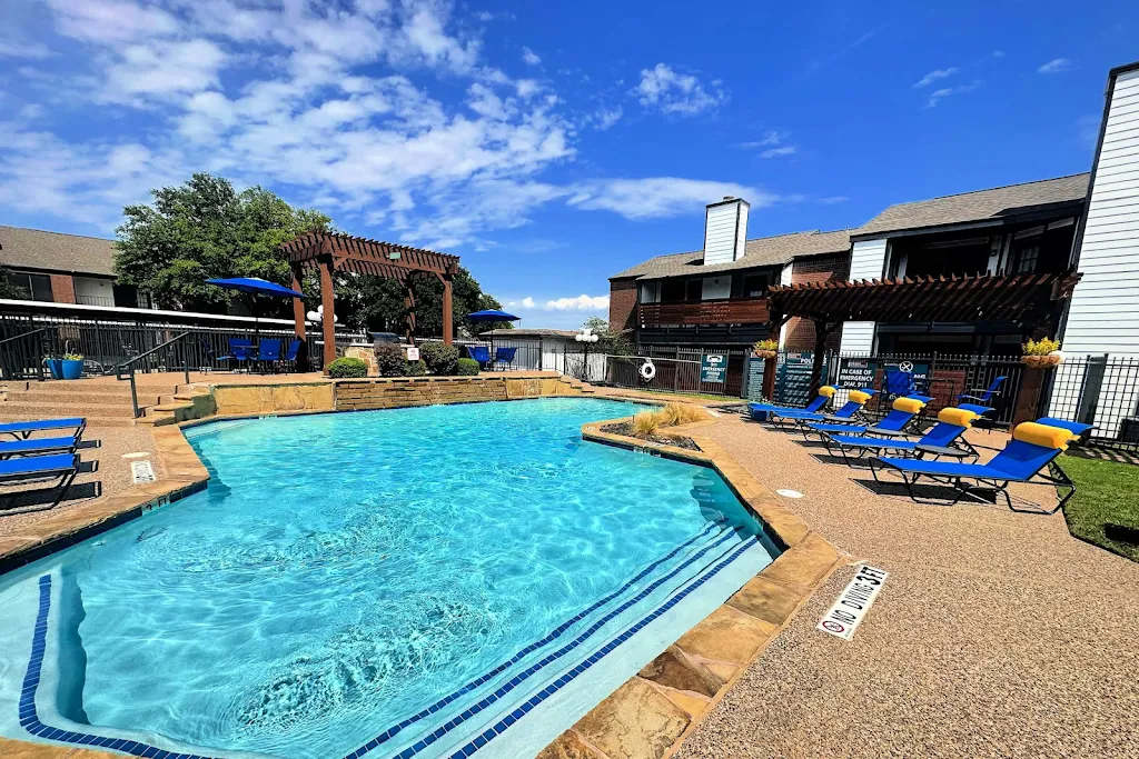 Barrett Creek swimming pool with stone patio and blue lounge chairs