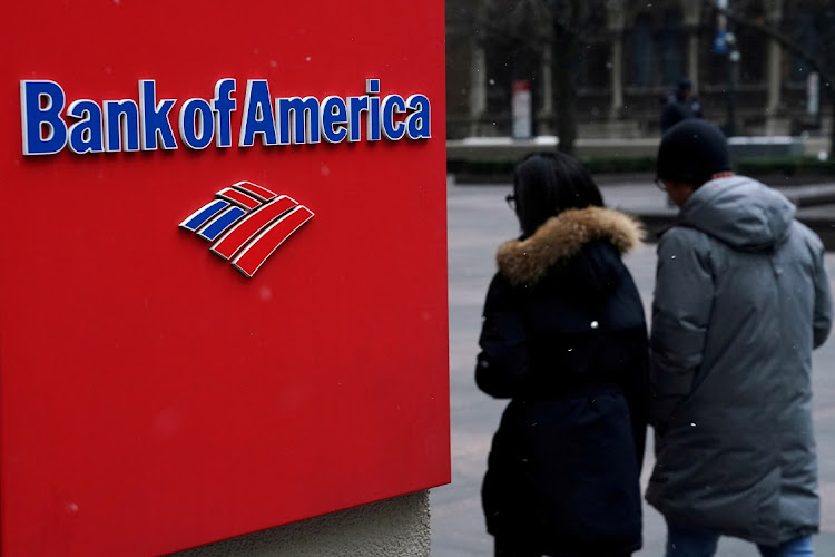 People walk past a Bank of America sign in New York, the US. The company gave another $22.1m to its Neighborhood Builders and Champions programmes that support non-profits. Picture: CARLO ALLEGRI/REUTERS