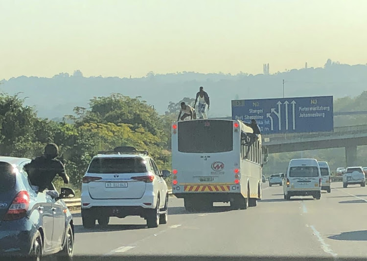 In a video clip posted on Twitter, several passengers are seen walking on the vehicle's roof at the Spaghetti Junction interchange.