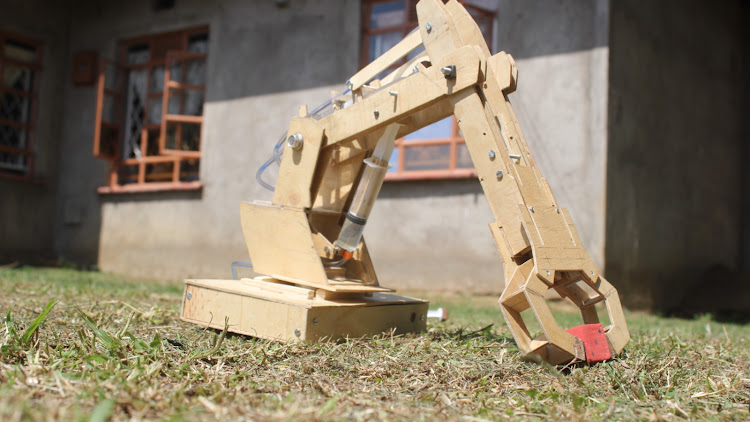 The hydraulic arm machine that Ethan invented at their Sikata home.