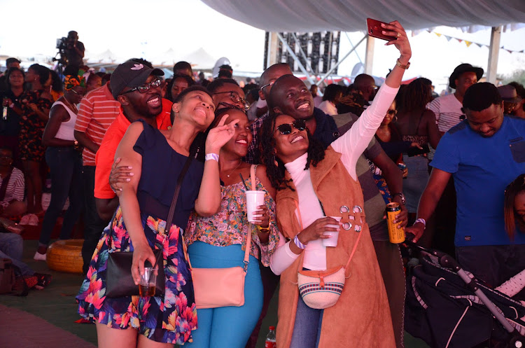 Fans take selfies during the event