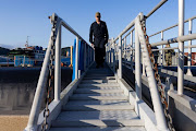 A member of the US Navy exits the USS Kentucky ballistic missile submarine in Busan, South Korea, on Wednesday, July 19, 2023. North Korea launched two missiles into waters off its east coast in a show of anger hours after the US brought a submarine capable of firing nuclear ballistic missiles to a port in South Korea for the first time in about four decades. Photographer: SeongJoon Cho/Bloomberg