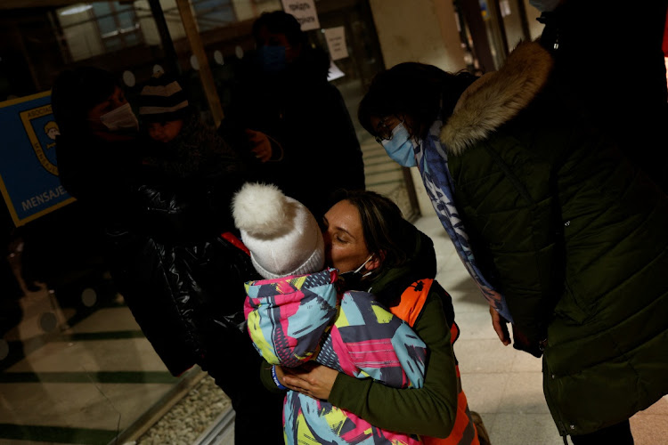 Marta Rodriguez, a taxi driver, bids farewell to Elina, 4, after finishing their trip from Poland to Madrid, Spain, March 17, 2022.