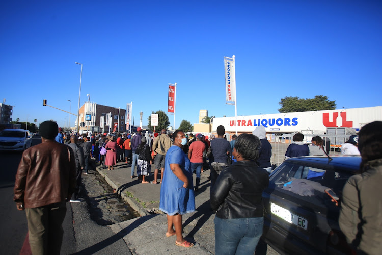 People gather outside Ultra Liquors in Oxford Street, East London, on the first day of level 3, when the ban on alcohol sales was lifted.