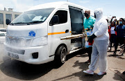 Ward 28 committee member Sabelo Zuma disinfects a taxi at the launch of the public transport sanitation programme at the Chesterville taxi rank in Durban on Friday.