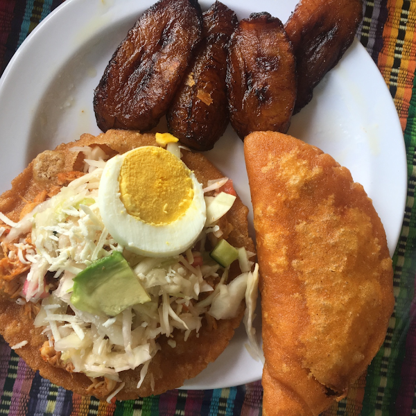 Fried plantains, chicken enchilada (open faced one), and beef pastele.