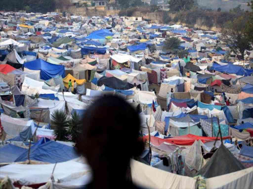 A boy stands at a makeshift camp on the grounds of the Petionville Golf Course in Port-au-Prince, Haiti in this January 26, 2010 file photo. /REUTERS