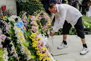 Australian Bali bombing survivor, Andrew Csabi lays a flower during the commemoration of the 20th anniversary of the Bali bombing that killed 202 people, mostly foreign tourists, including 88 Australians and seven Americans, at the Australian Consulate in Denpasar, Bali, Indonesia, October 12, 2022. 