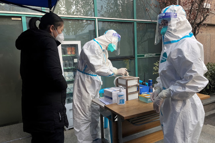 A medical worker registers information for a patient at the Central Hospital of Wuhan on December 31 2022 as the country experiences a spike in Covid-19 infections.