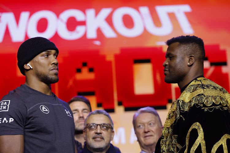 Anthony Joshua and Francis Ngannou face off at Outernet, in London, on Monday. Picture: ANDREW COULDRIDGE/REUTERS