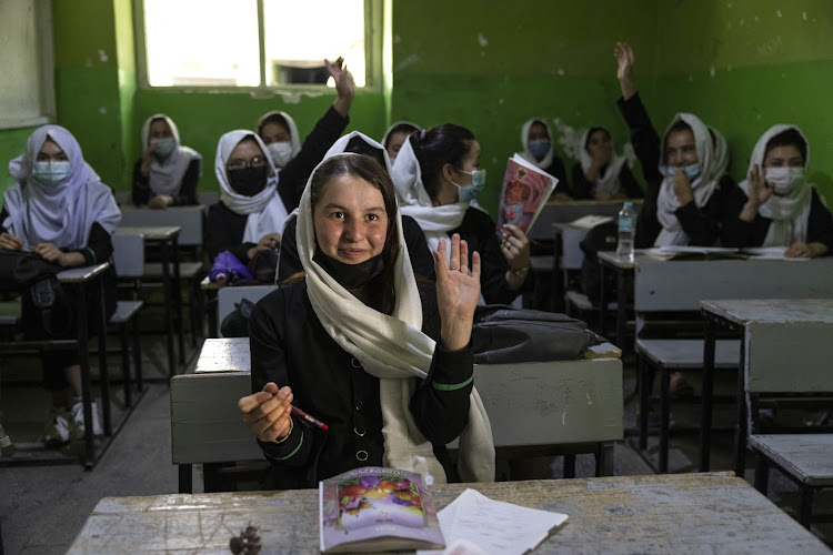 Zinat Karimi, 17, raises her hand during 10th-grade class at the Zarghoona high school on July 25 2021 in Kabul, Afghanistan. File picture